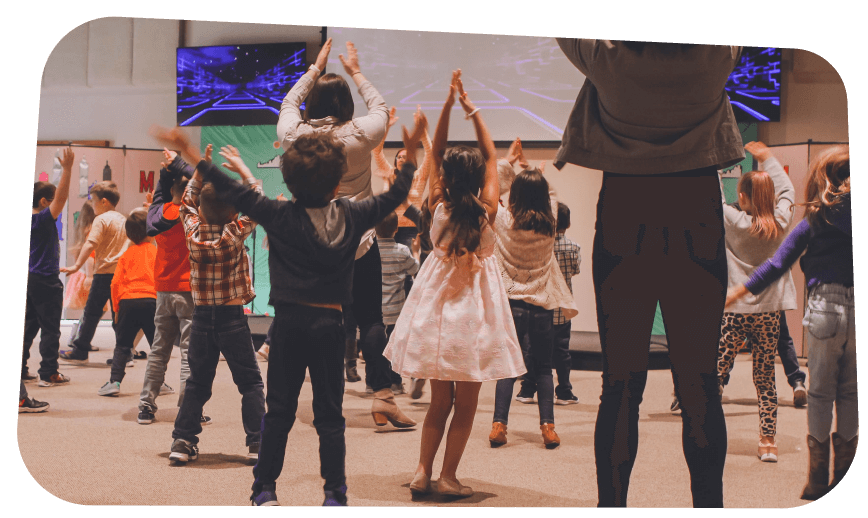 Group of students and teachers practicing a dance at a community center